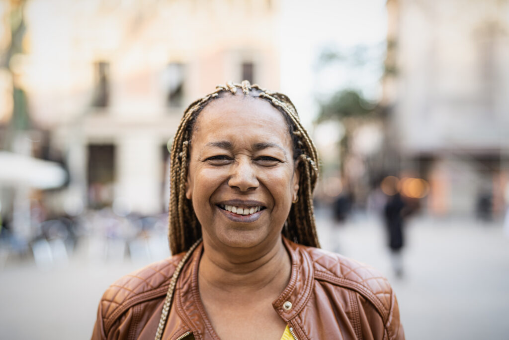 happy african woman having fun in city elderly people concept